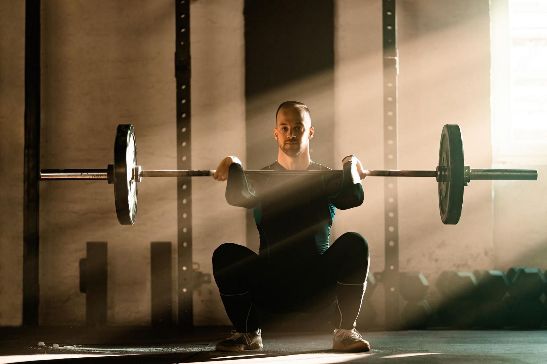 Weighted sumo squats. (Image via Freepik)