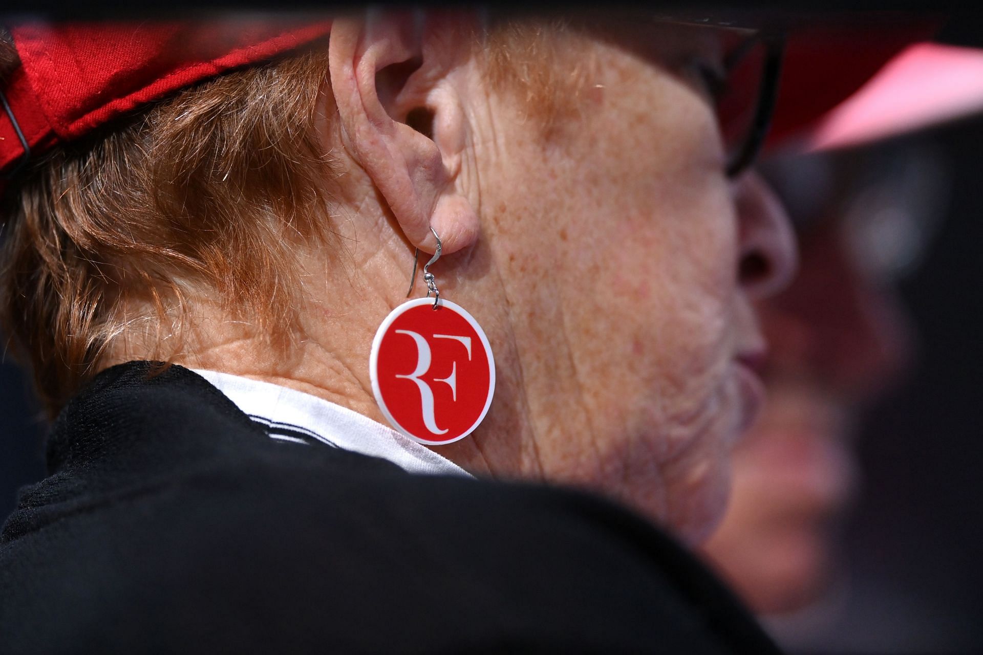 A woman wears Roger Federer earrings: Paris Masters