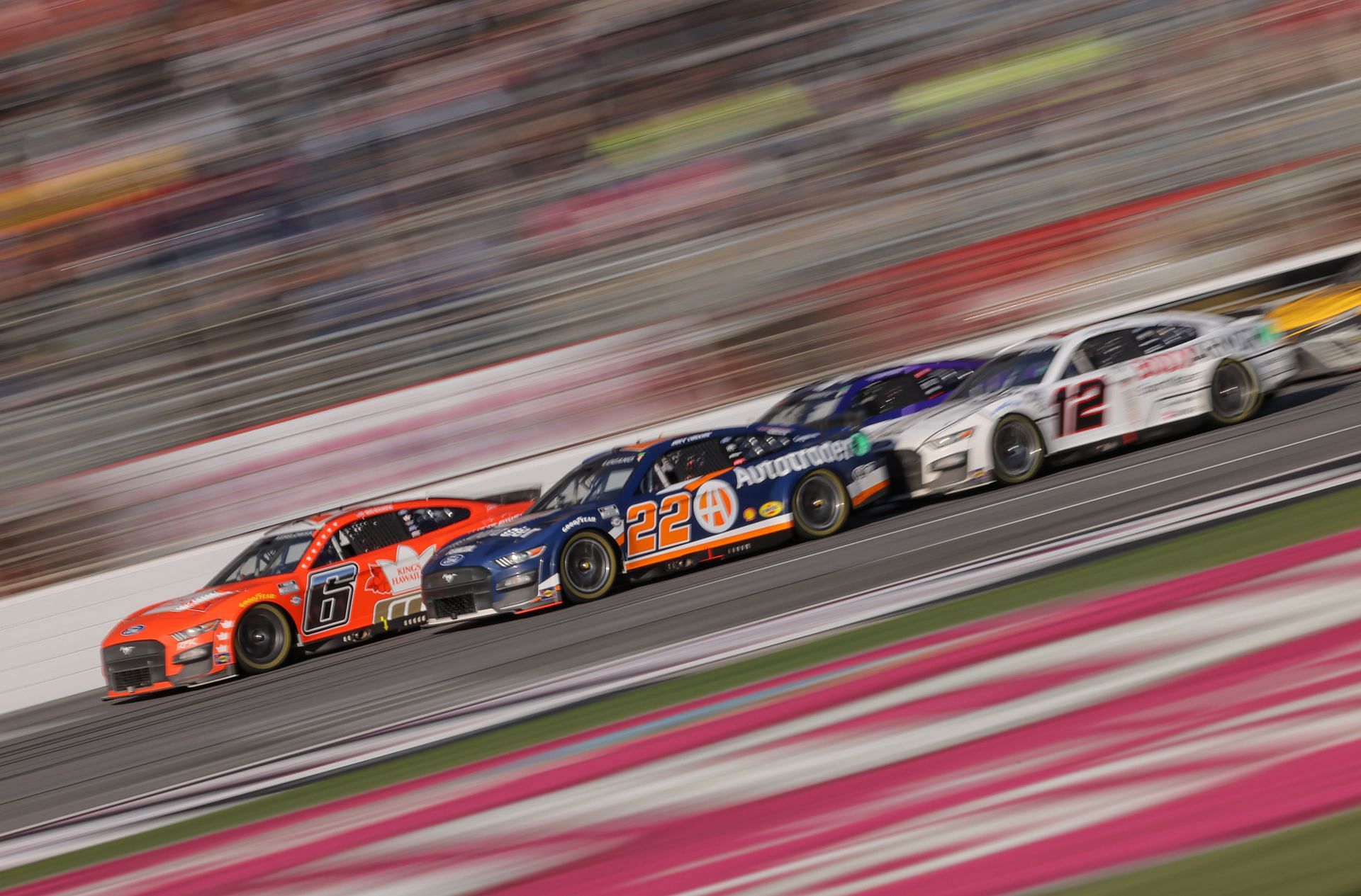 Brad Keselowski leads Joey Logano