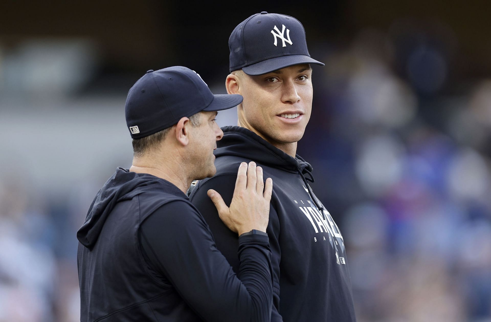 Aaron Judge (R) and manager Aaron Boone of the New York Yankees celebrate after defeating the Texas Rangers at Yankee Stadium