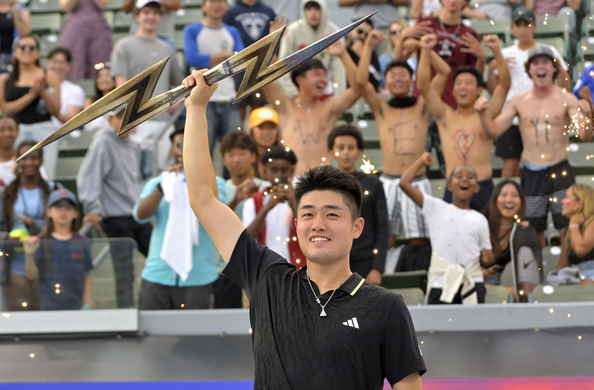 Yibing Wu lifts the Ultimate Tennis Showdown trophy in Los Angeles.
