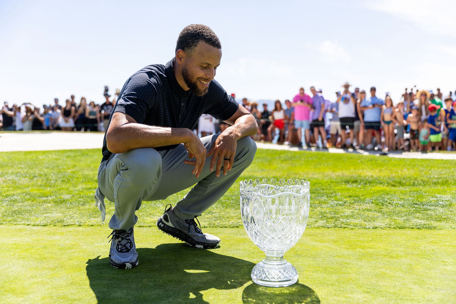Steph Curry with the 2023 Lake Tahoe Celebrity Golf Tournament trophy (via Getty Images)