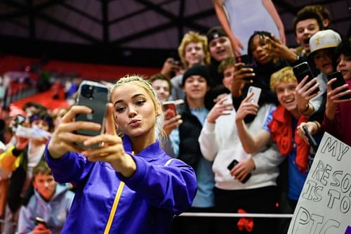 Oliva Dunne taking a 'selfie' with fans in an LSU v Utah match in Salt Lake City, 2023