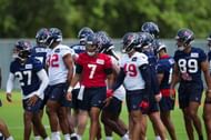 C.J. Stroud #7 of the Houston Texans walks out of a team huddle during the first day of Houston Texans Rookie Minicamp at NRG Stadium