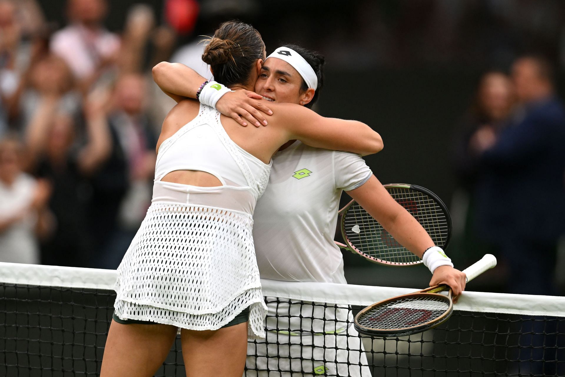 Aryna Sabalenka and Ons Jabeur share a hug after their 2023 Wimbledon Championships semifinal.
