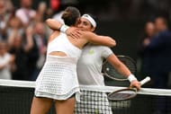 Aryna Sabalenka and Ons Jabeur share a hug after their 2023 Wimbledon Championships semifinal.