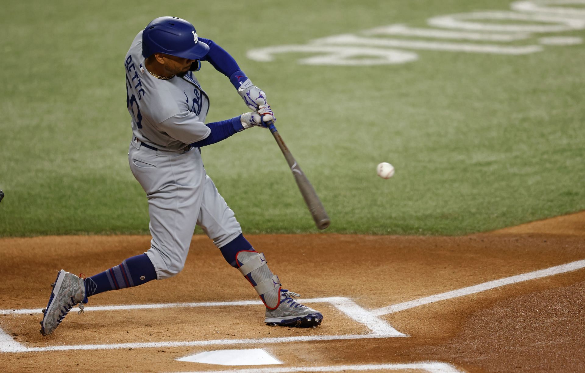 Mookie Betts #50 of the Los Angeles Dodgers hits a double during the first inning of the game against the Texas Rangers at Globe Life Field on July 23, 2023 in Arlington, Texas. (Photo by Ron Jenkins/Getty Images)