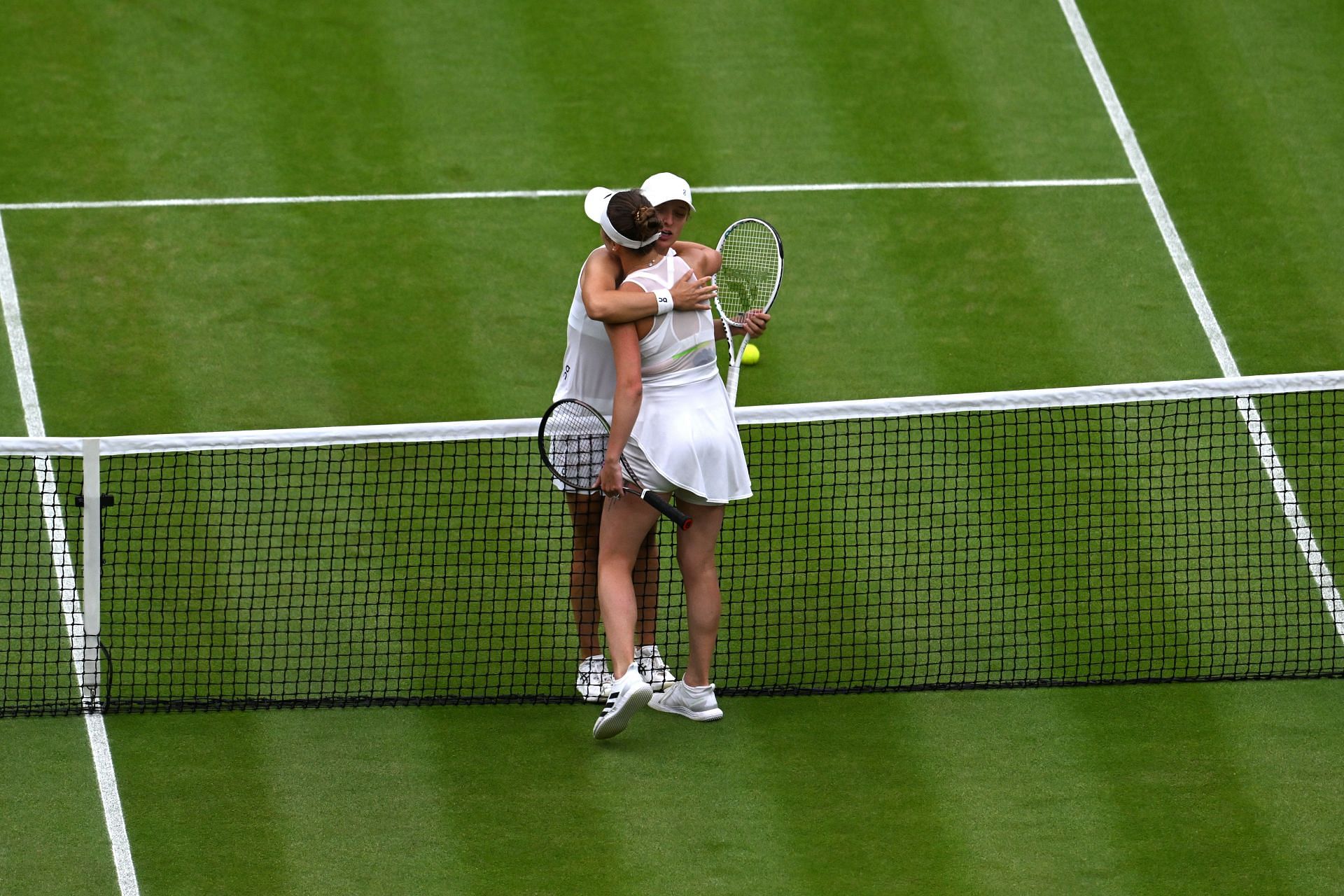 Iga Swiatek and Elina Svitolina hug after Wimbledon 2023 QF