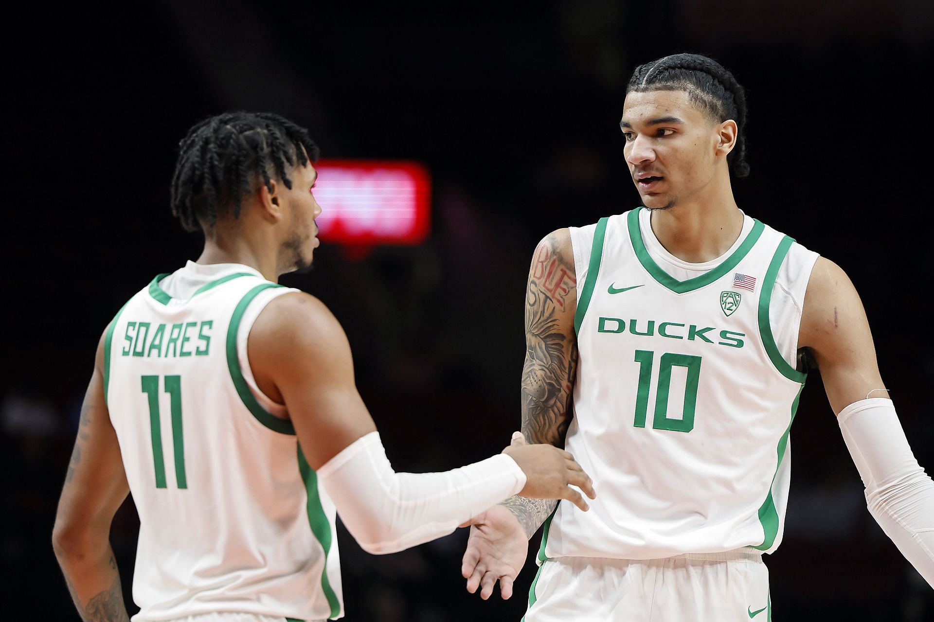 Kel&#039;el Ware #10 of the Oregon Ducks celebrates a basket and a foul with teammate Rivaldo Soares #11