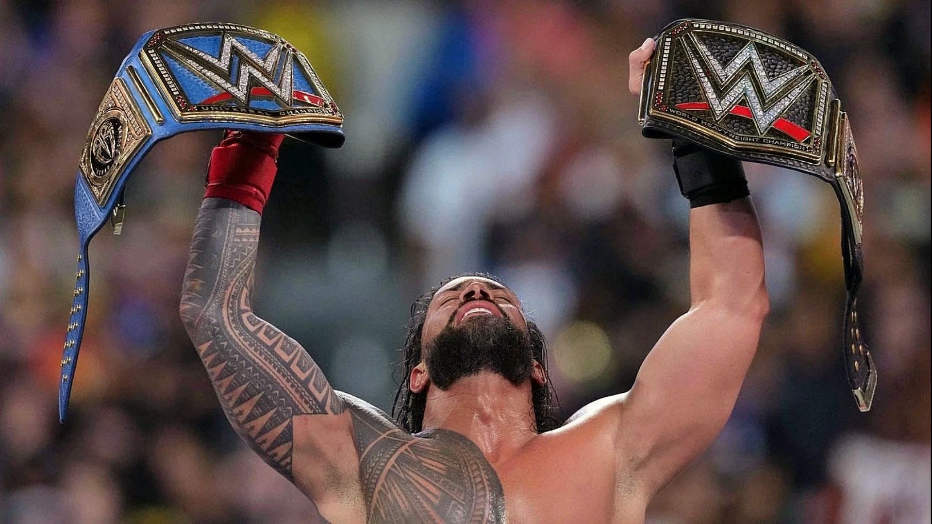 Roman Reigns holding the WWE and the Universal titles