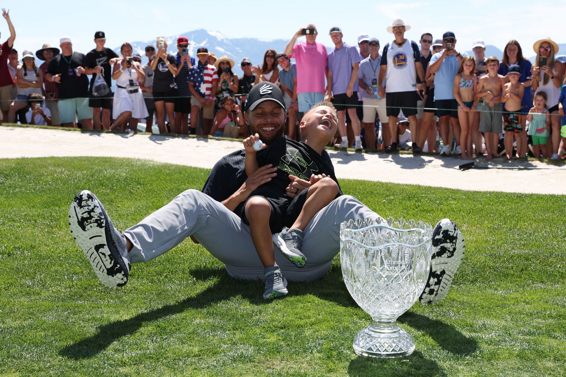 Steph Curry with his son at the 2023 Lake Tahoe Celebrity Golf Tournament (via Getty Images)