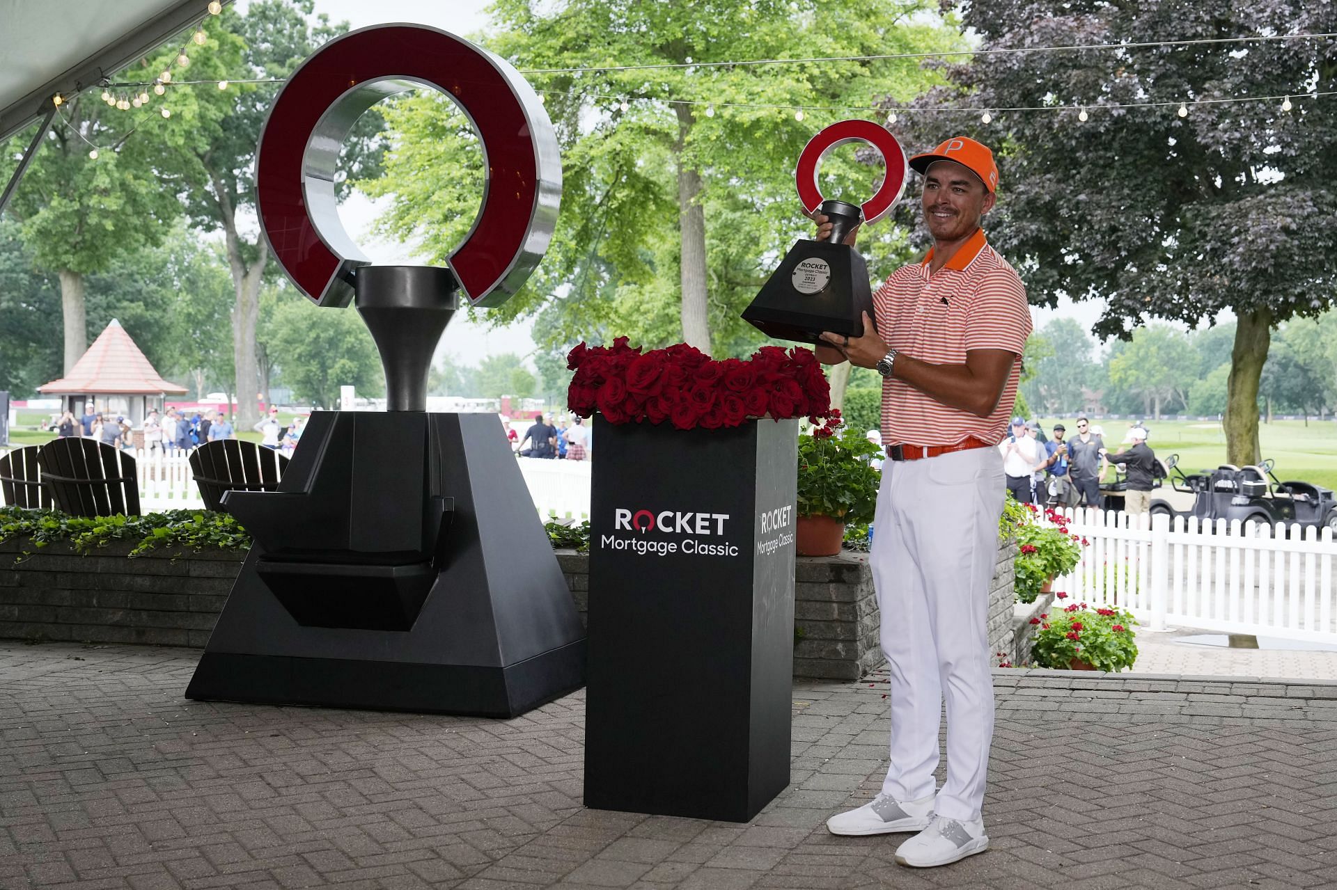 Rickie Fowler poses with the Rocket Mortgage Classic trophy