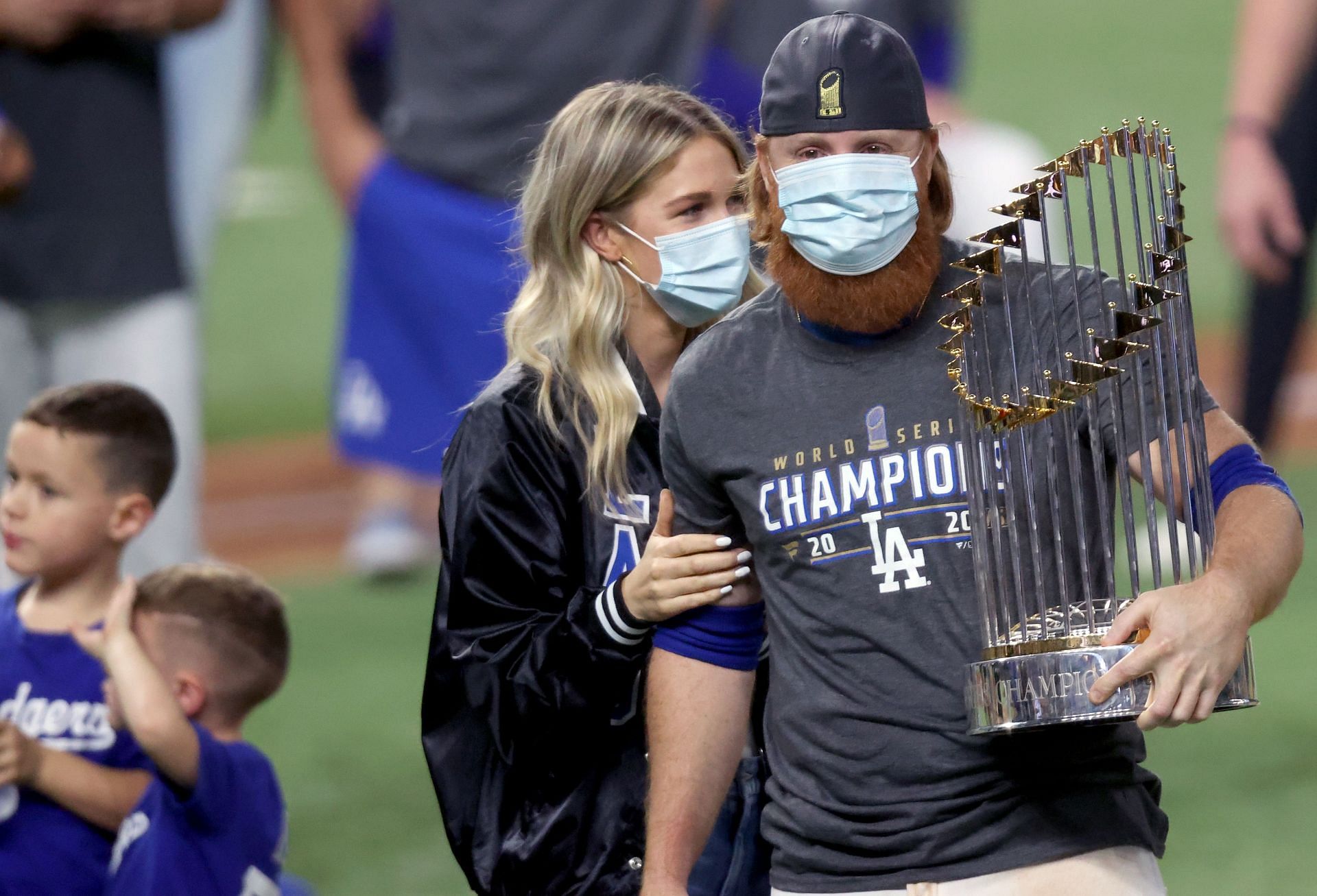 Justin Turner #10 of the Los Angeles Dodgers and his wife Kourtney Pogue, hold the Commissioners Trophy after the team&#039;s 3-1 victory against the Tampa Bay Rays in Game Six to win the 2020 MLB World Series at Globe Life Field on October 27, 2020 in Arlington, Texas. (Photo by Tom Pennington/Getty Images)