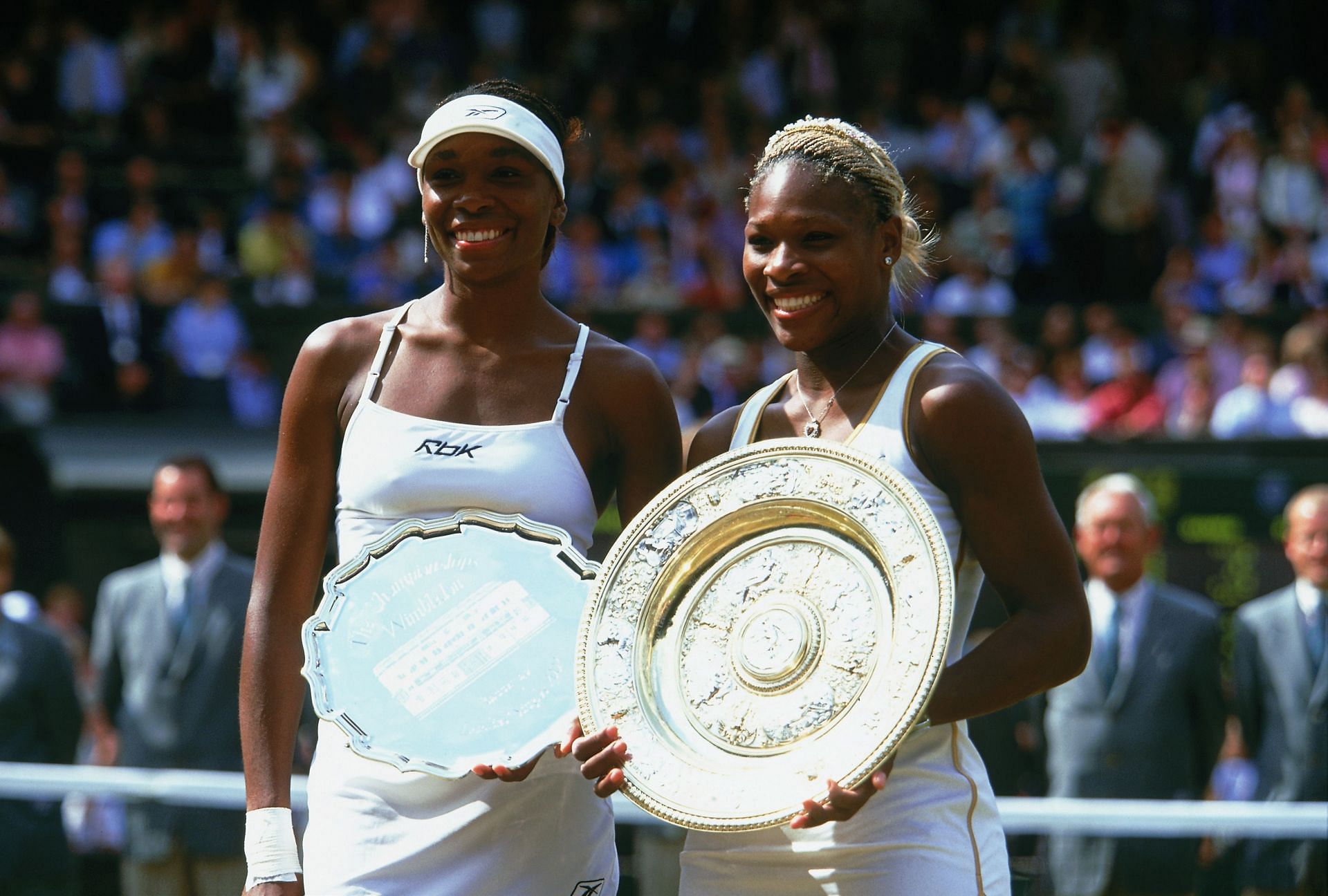 Wimbledon Ladies champion Serena Williams (right) of the USA poses with the winning trophy with runner-up and sister Venus Williams of the USA