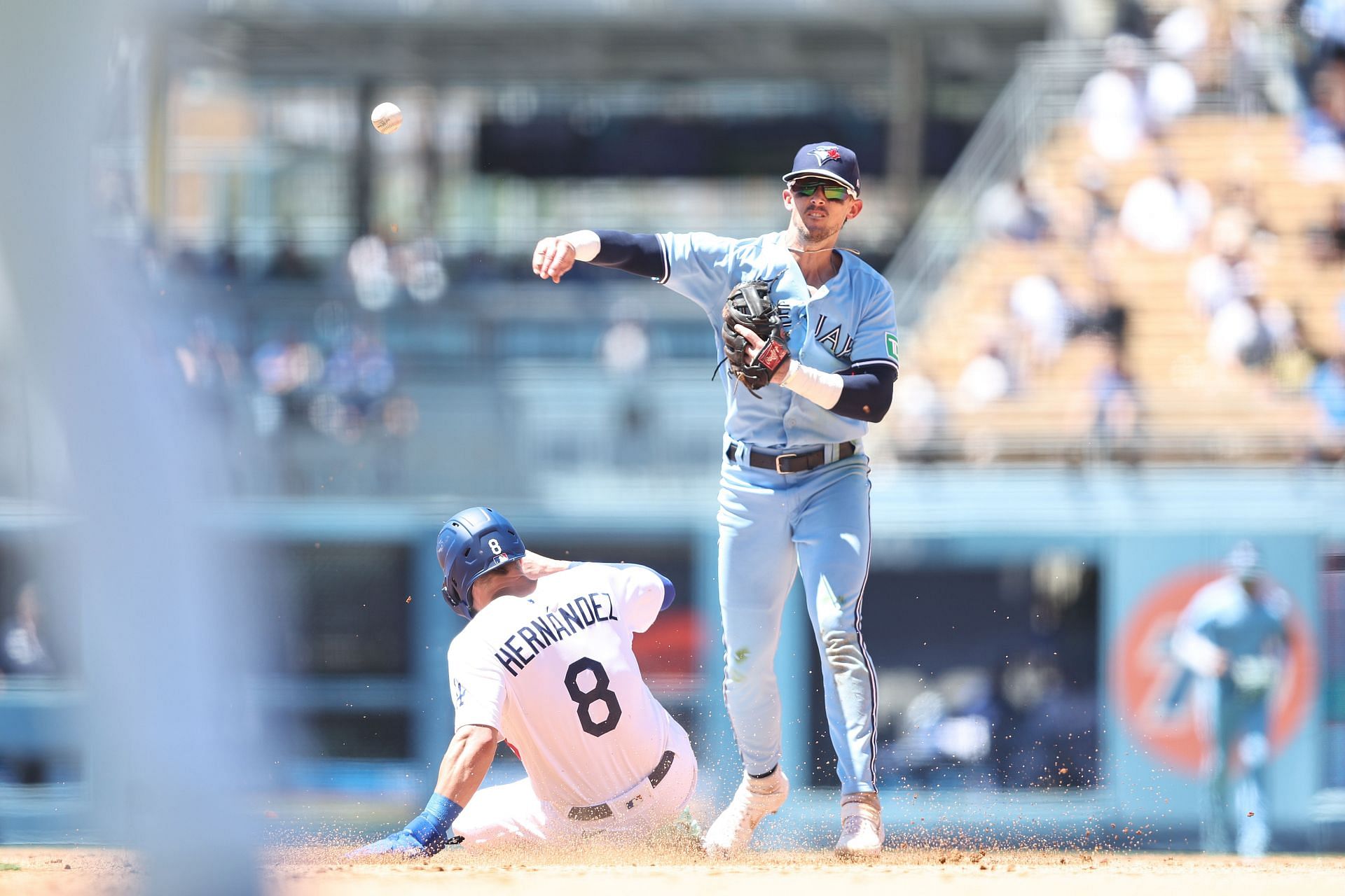 Cavan Biggio #8 of the Toronto Blue Jays tags out Enrique Hern&aacute;ndez #8 of the Los Angeles Dodgers and throws to first for a double play during the fourth inning at Dodger Stadium on July 26, 2023 in Los Angeles, California. (Photo by Michael Owens/Getty Images)