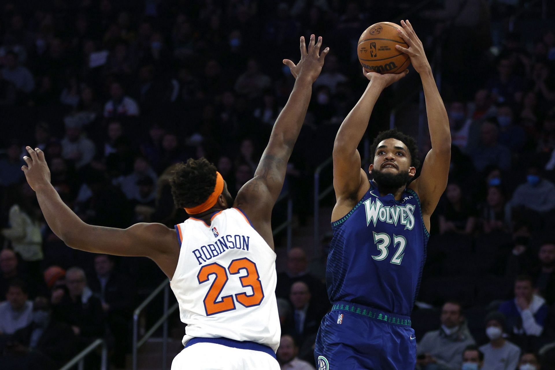 Karl-Anthony Towns of the Minnesota Timberwolves shooting over Mitchell Robinson of the New York Knicks