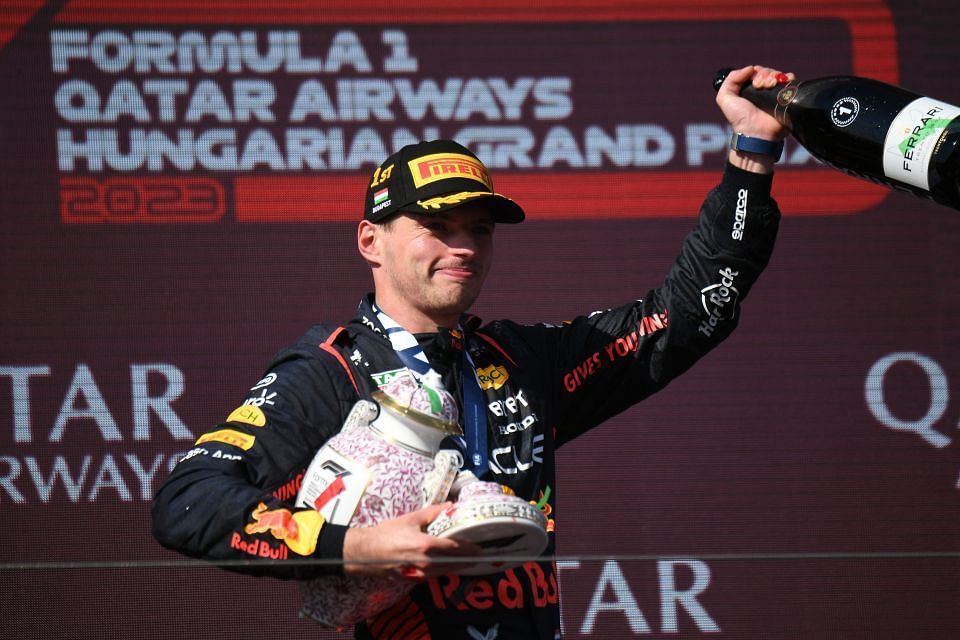 Max Verstappen with his broken trophy