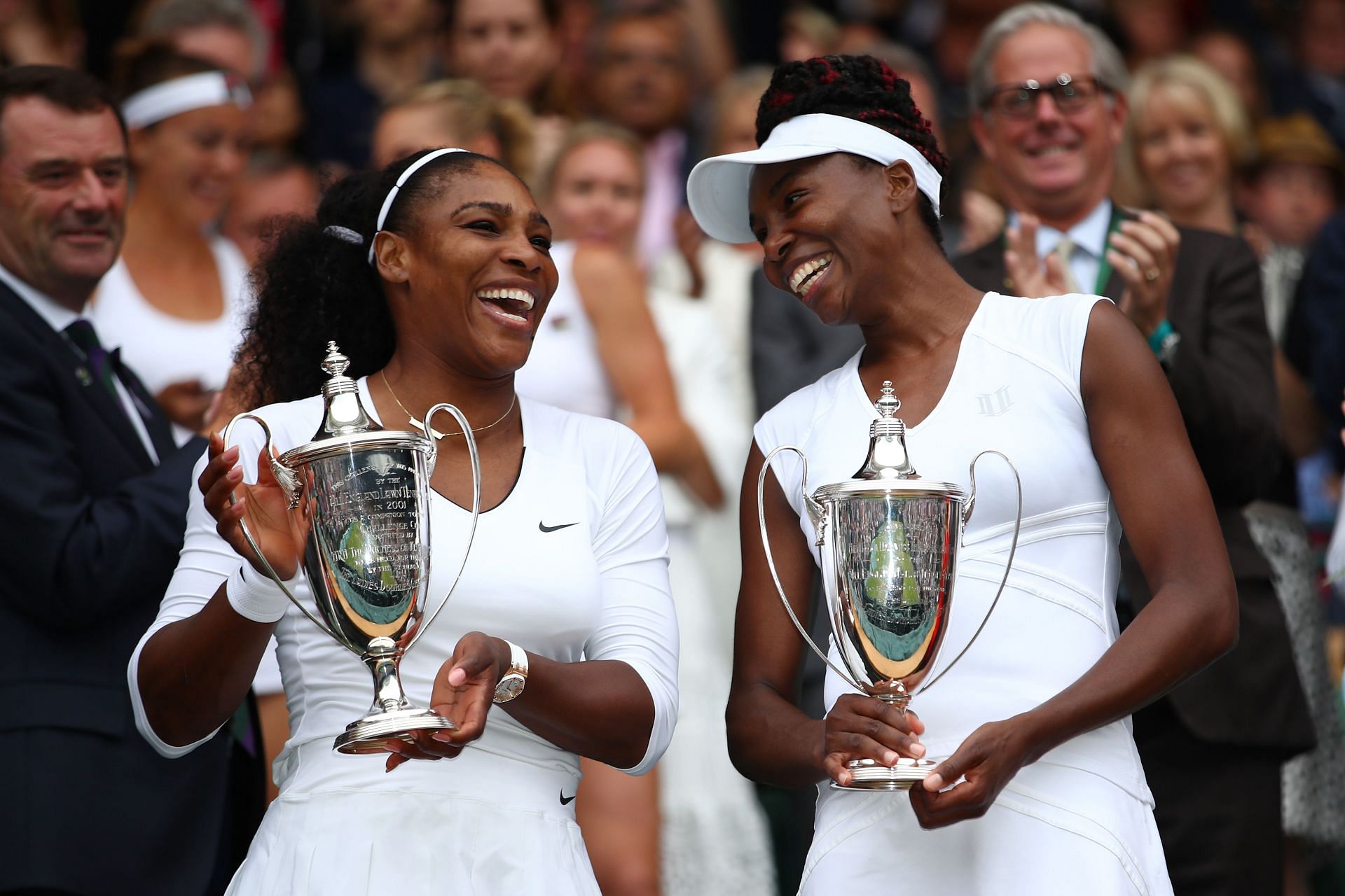 Serena Williams and Venus Williams with the women&#039;s doubles trophy at Wimbledon 2016
