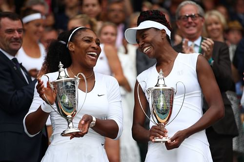 Serena Williams and Venus Williams with the women's doubles trophy at Wimbledon 2016