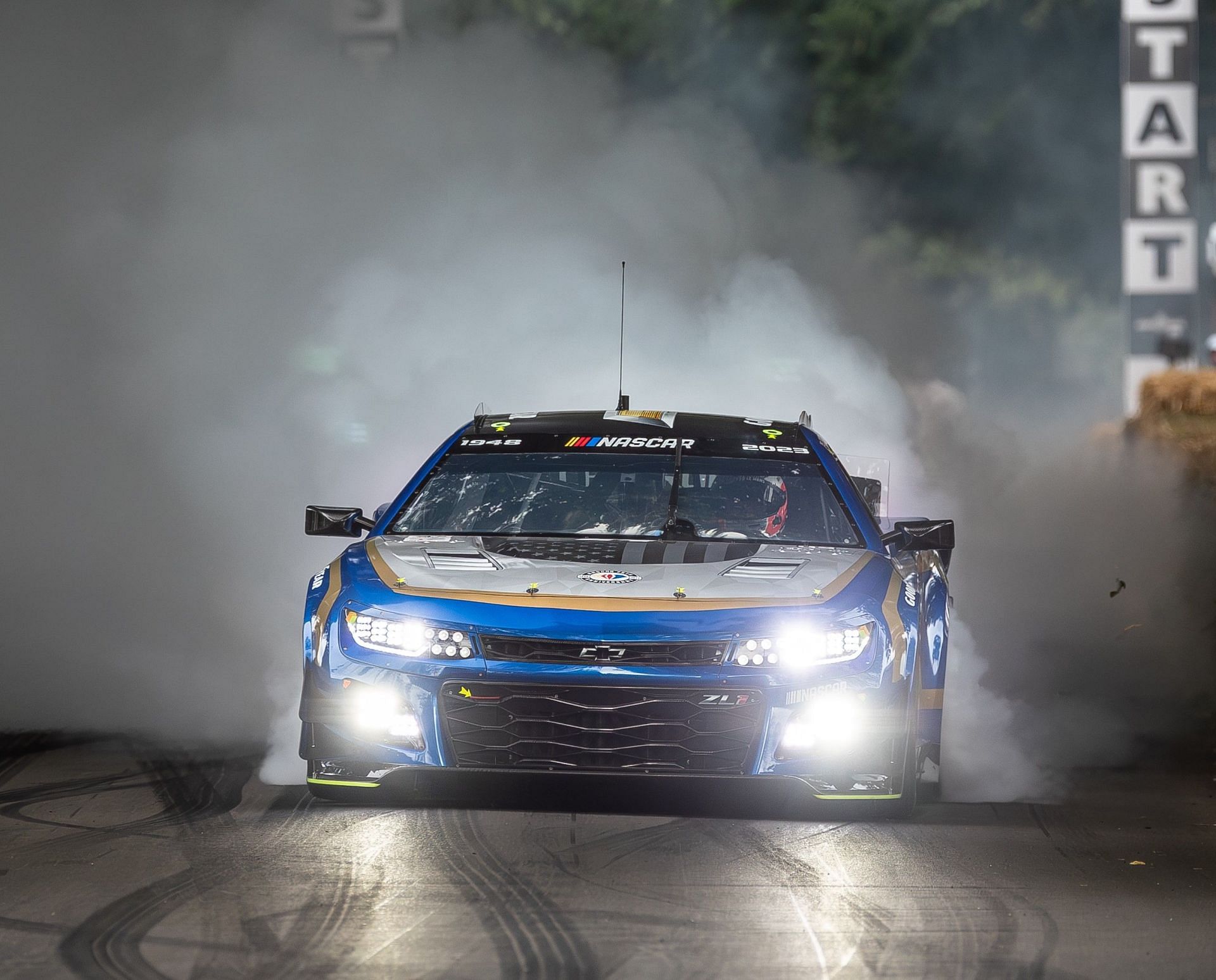 Jenson Button performs a burnout in the NASCAR Garage 56 car in front of the crowd at the 2023 Goodwood Festival of Speed in Goodwood, England. Picture Credits: Goodwood Festival of Speed YouTube channel