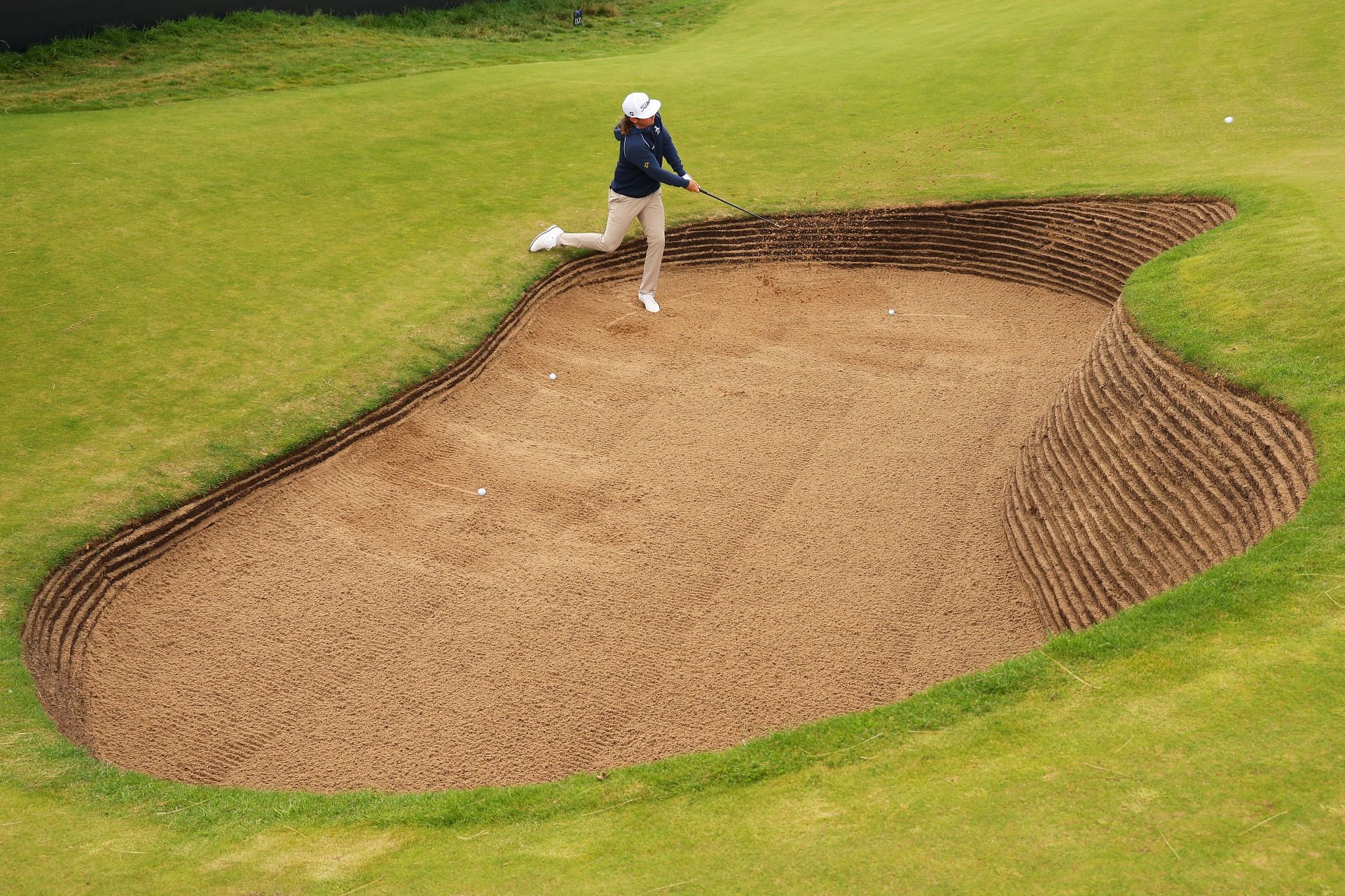 Cameron Smith plays a shot from a bunker on the 17th hole during a practice round ahead of The 151st Open at the Royal Liverpool Golf Club