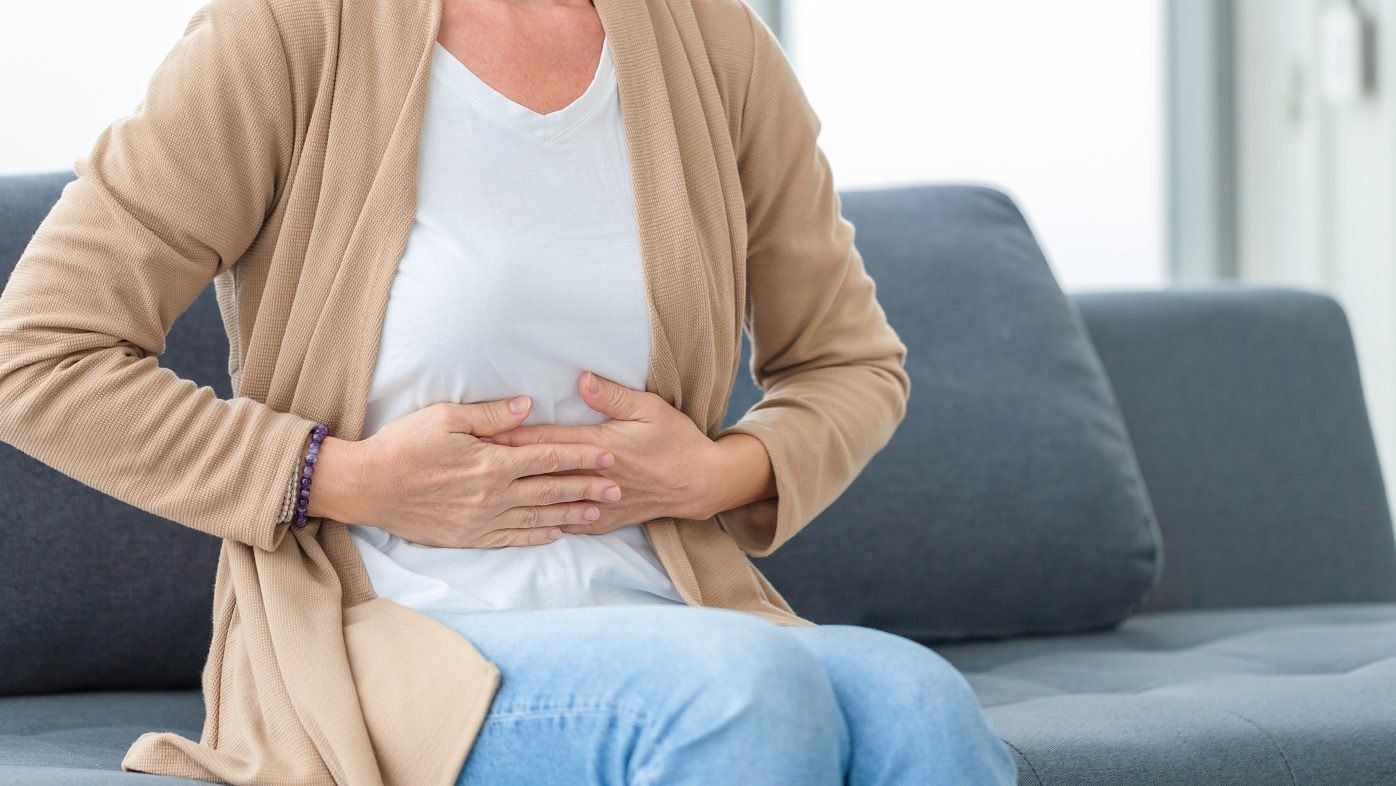 Abdominal pain (Image via Getty Images)