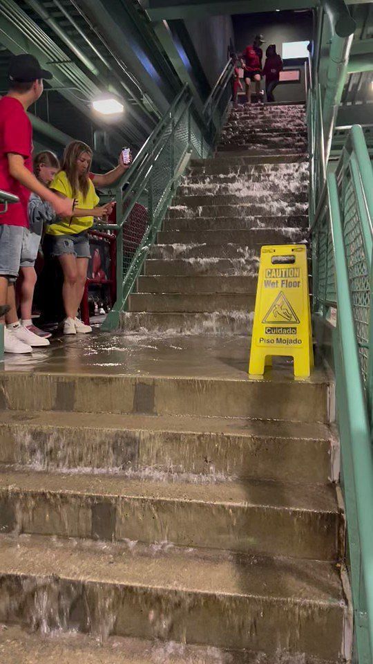 Red Sox fans take advantage of flooded Fenway Park during rain delay