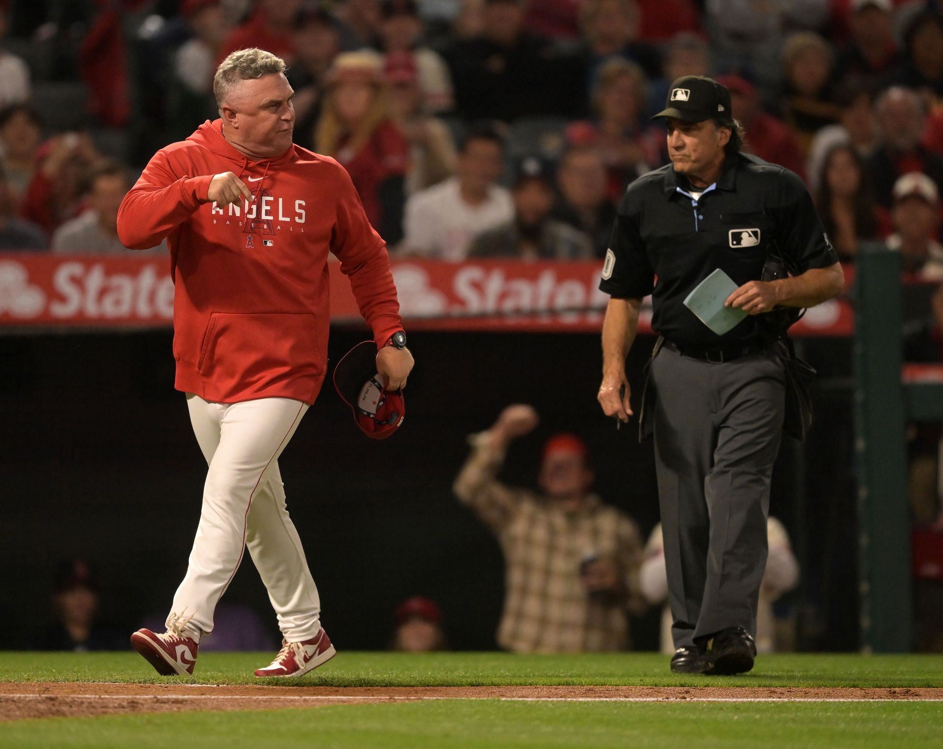 Manager Phil Nevin #88 of the Los Angeles Angels yells at umpire Phil Cuzzi #10 after Shohei Ohtani #17 was called out on ball four leaving two runners on base to end the fifth inning against the Seattle Mariners at Angel Stadium of Anaheim on June 10, 2023 in Anaheim, California. Nevin was ejected from the game. (Photo by Jayne Kamin-Oncea/Getty Images)