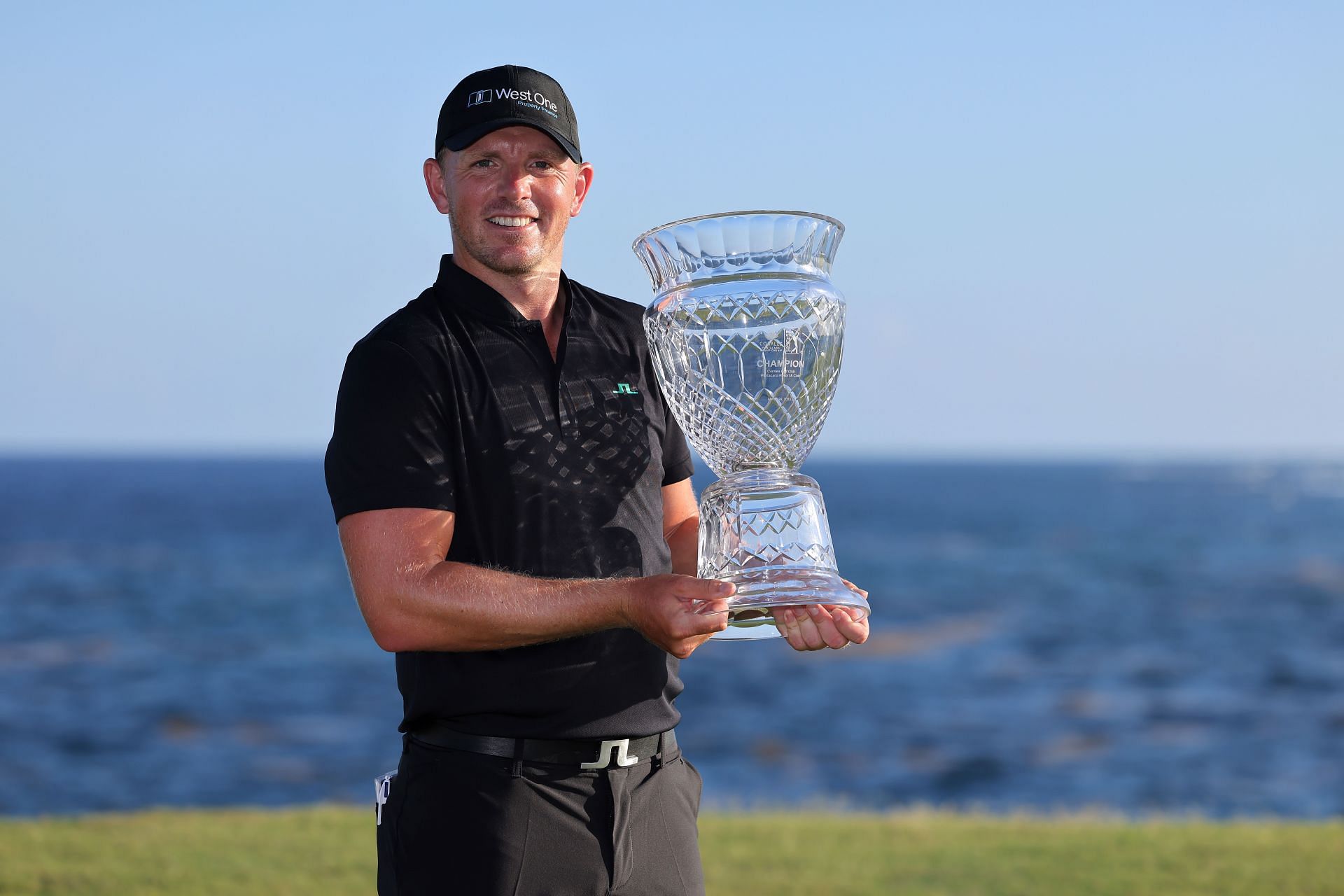 Matt Wallace with Corales Puntacana Championship trophy, 2023 (via Getty Images)
