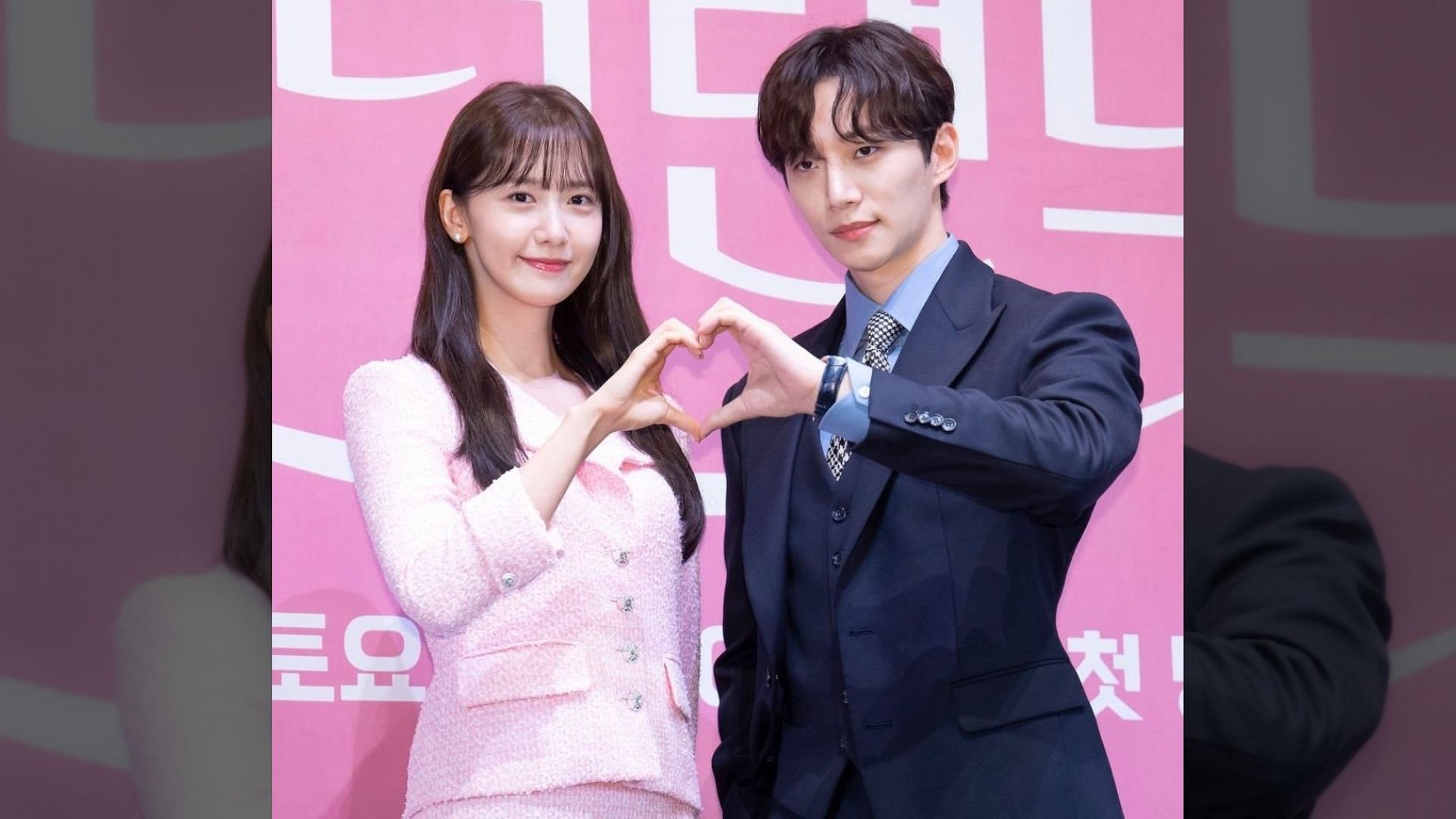 Rumored couple YoonA and Junho make a heart together at a press conference.