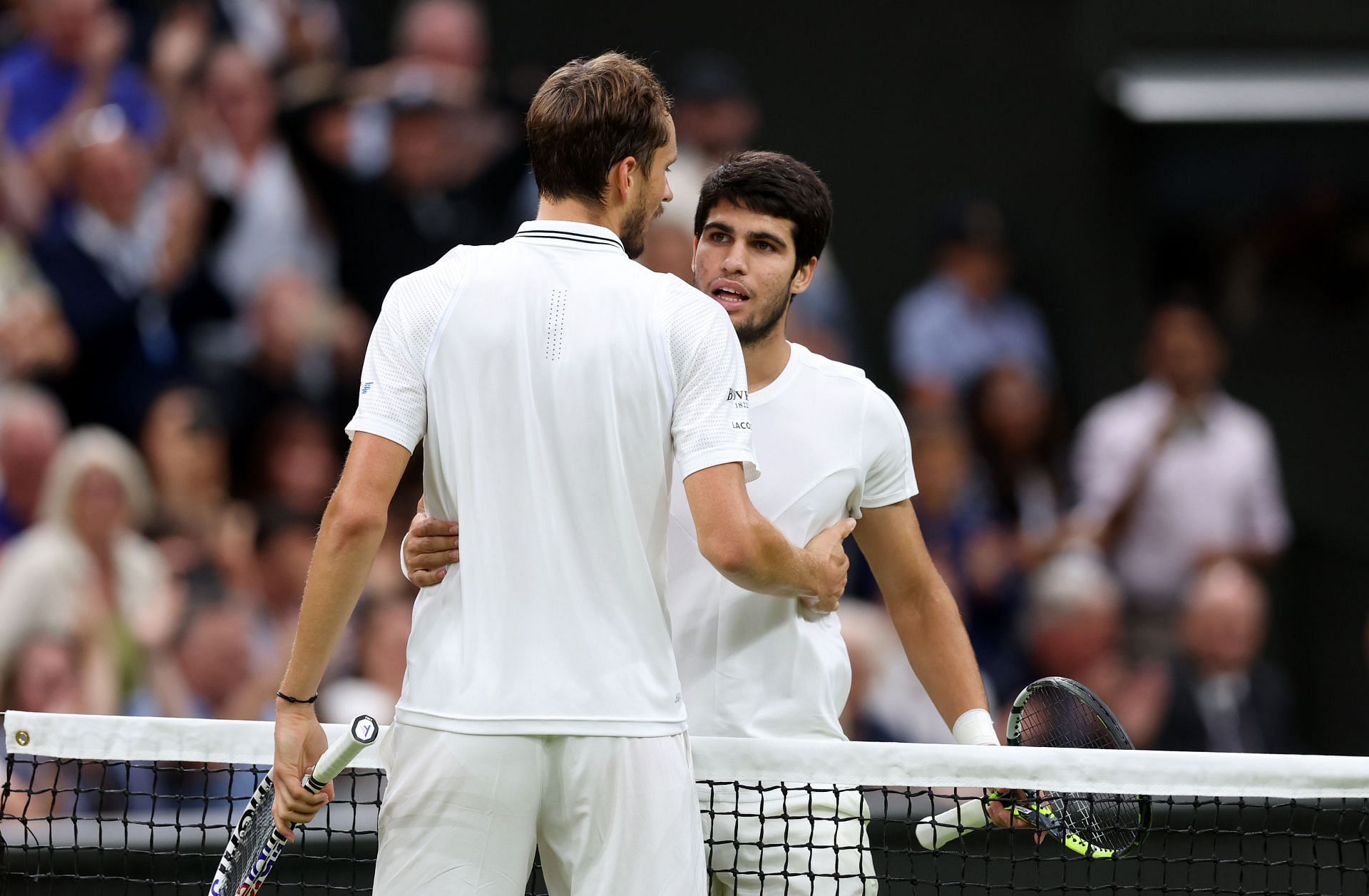 Alcaraz and Medvedev embrace at the net