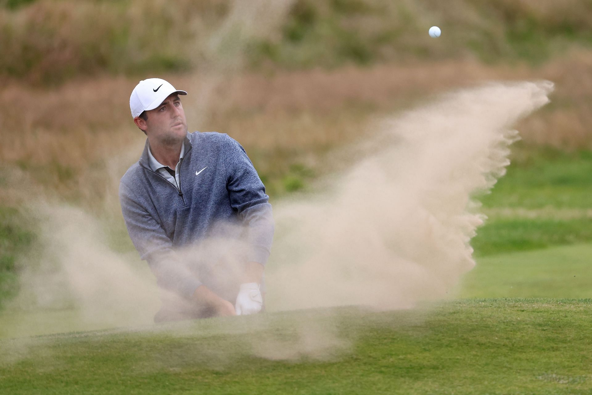 Scottie Scheffler playing a bunker shot in the Open Championship 2023 (via Getty Images)