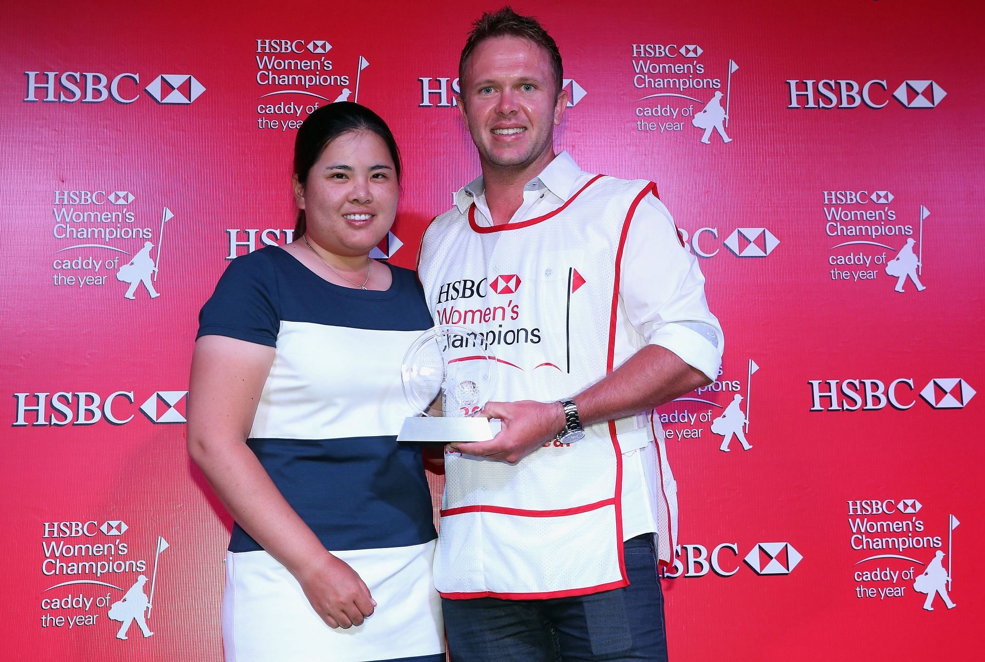 Brad Beecher poses alongside his player Inbee Park of South Korea with the trophy after being named the 2014 HBC Caddy Of The Year