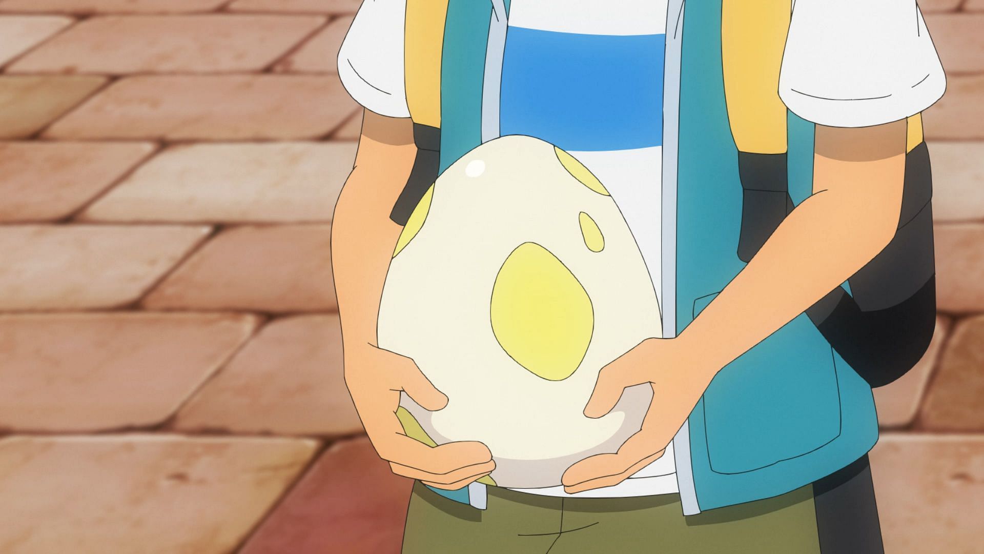 Ash holding an egg that appears similar to a 5 km egg in the anime (Image via The Pokemon Company)