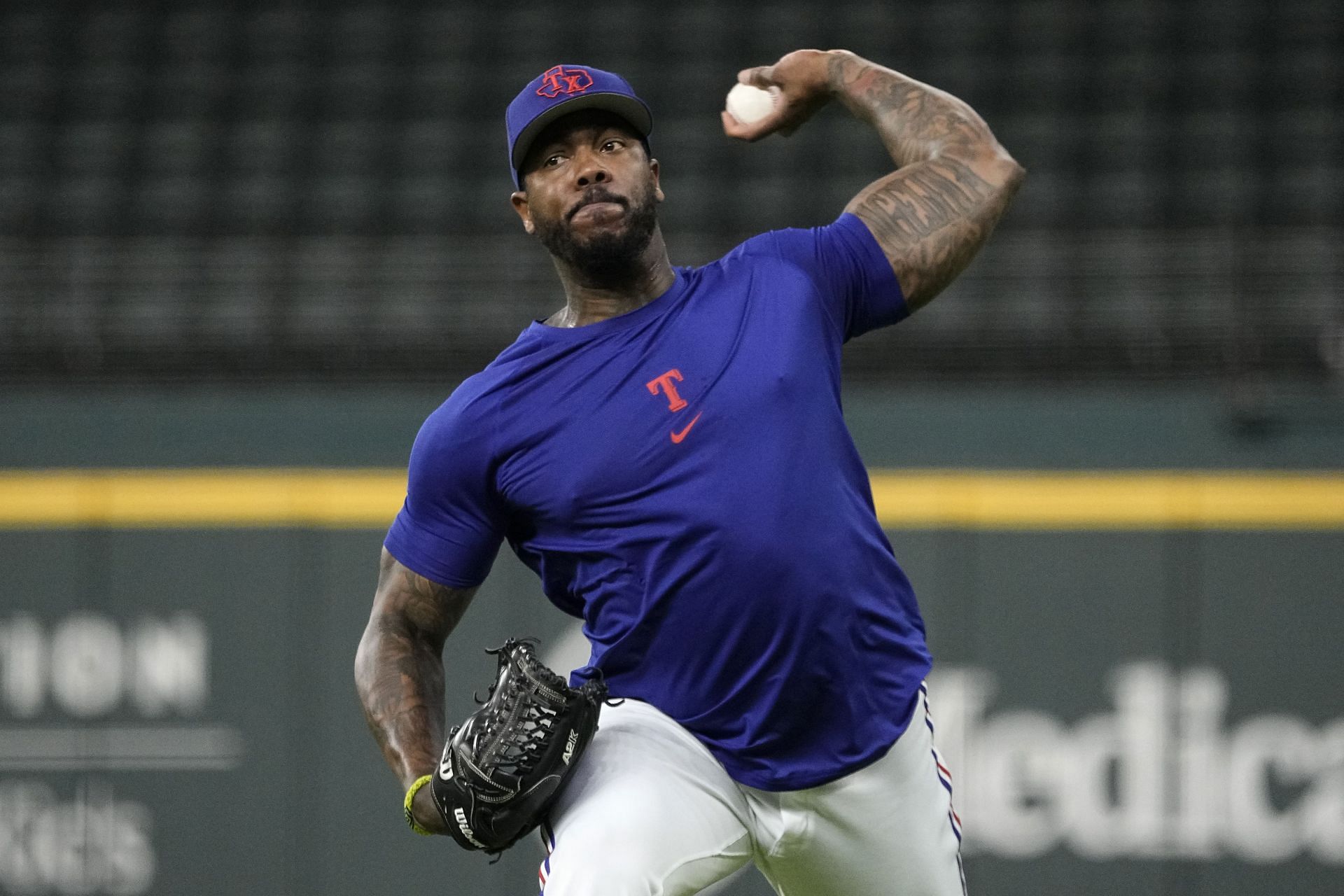 Aroldis Chapman of the Texas Rangers throws on the field before the game against the Houston Astros at Globe Life Field