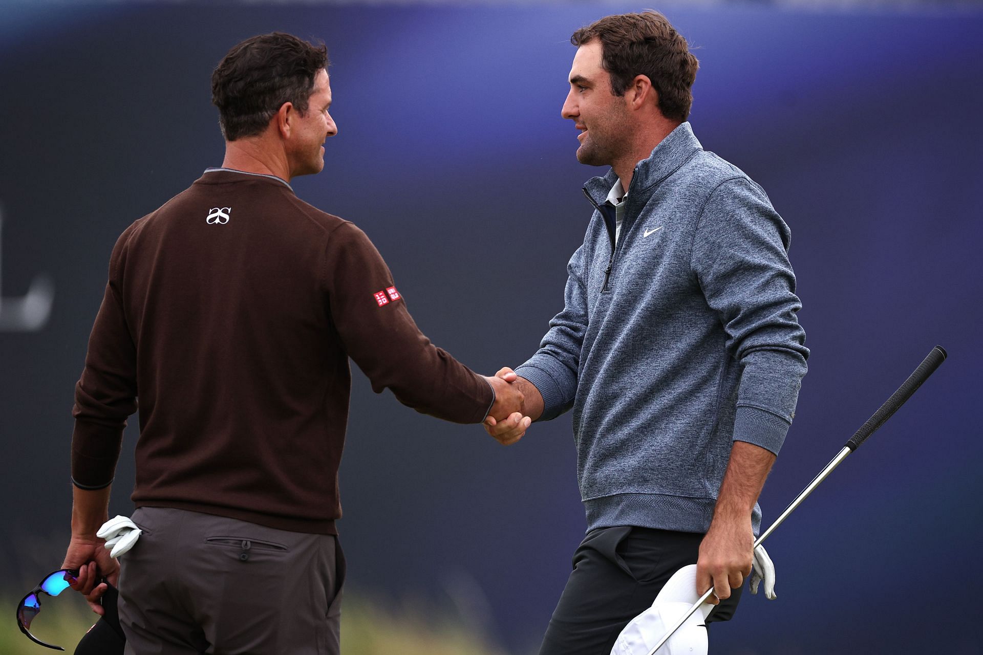 Adam Scott and Scottie Scheffler shaking hands (via Getty Images)