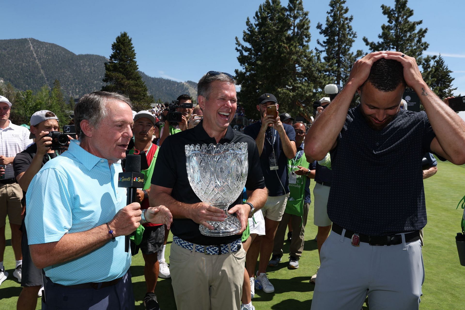 Johnathan Thomas presents the 2023 Lake Tahoe Golf Championship (ACC) trophy to Steph Curry (via Getty Images)