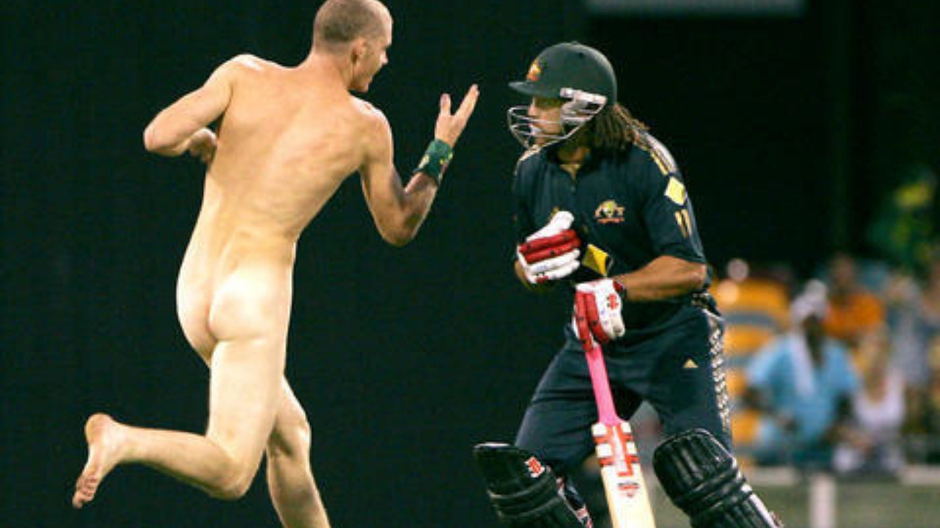 Andrew Symonds tackles down a pitch invader during a match in 2008.