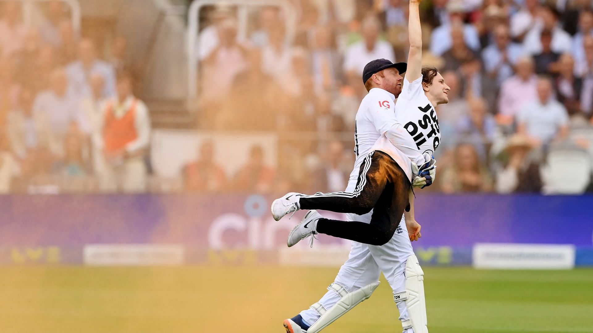 Jonny Bairstow carrying one of the pitch invaders during the ongoing Lord