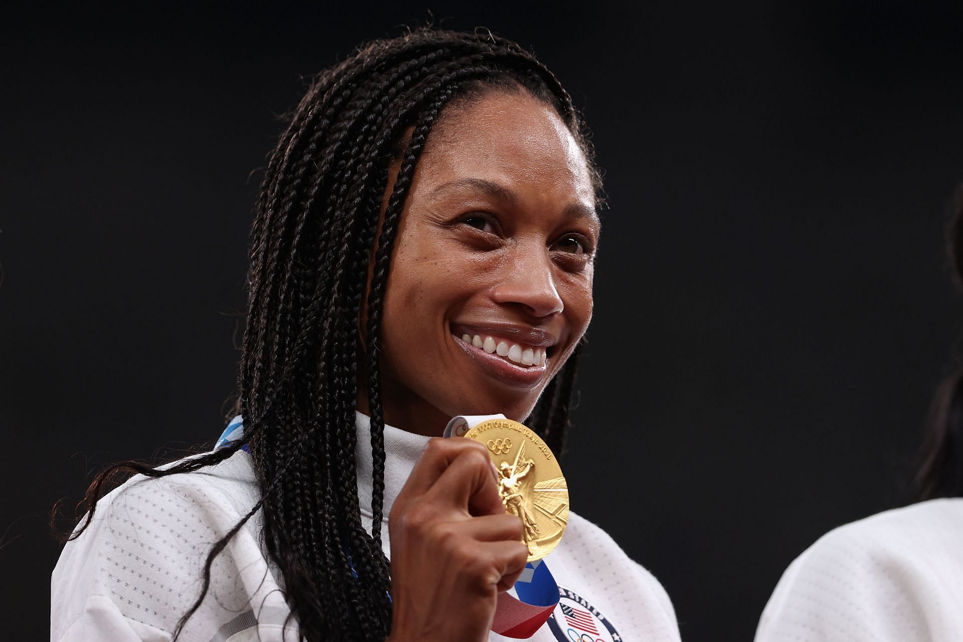 Felix on the podium at Tokyo Olympics winning gold in the 4x400m relay