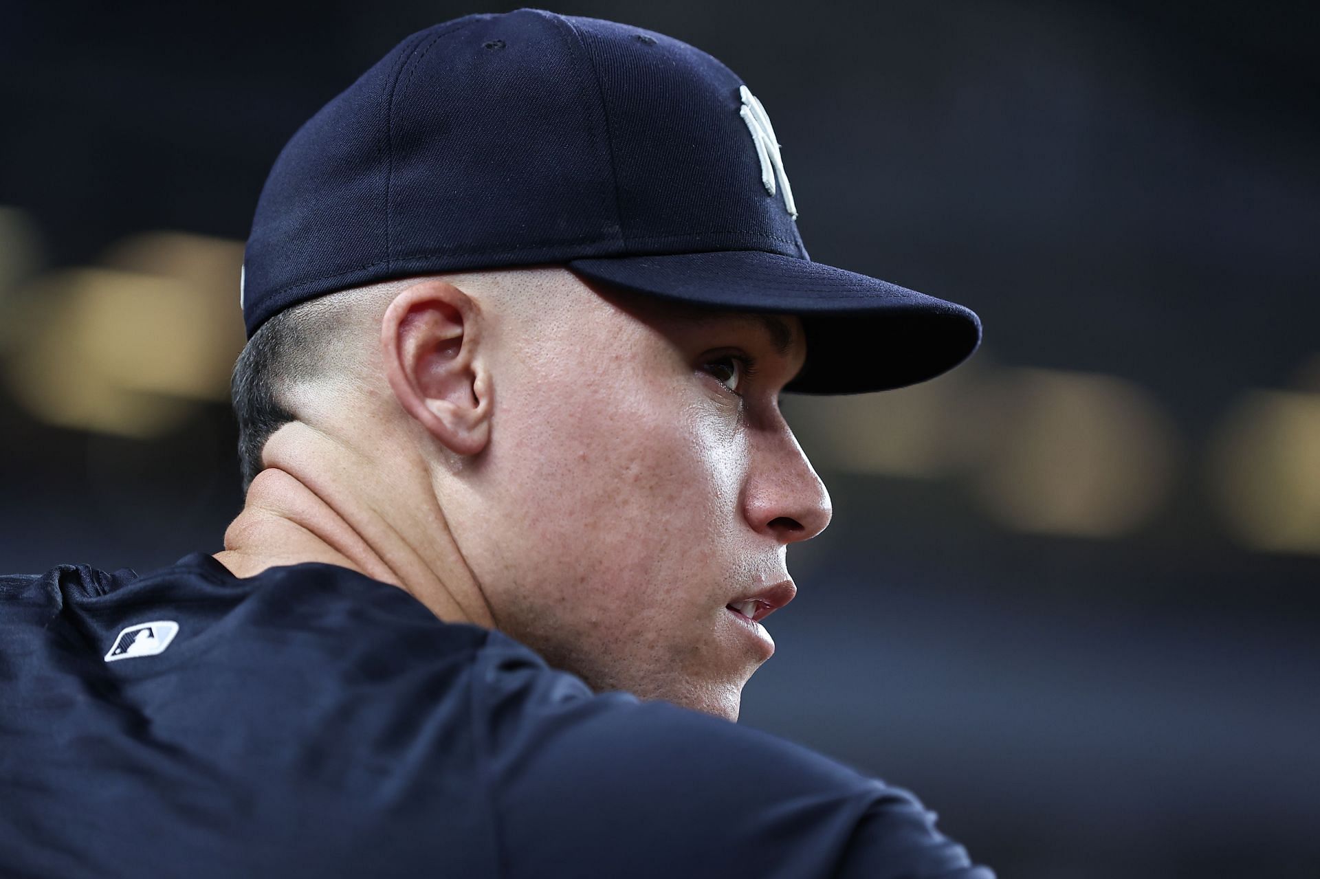 Aaron Judge #99 of the New York Yankees looks on from the dugout