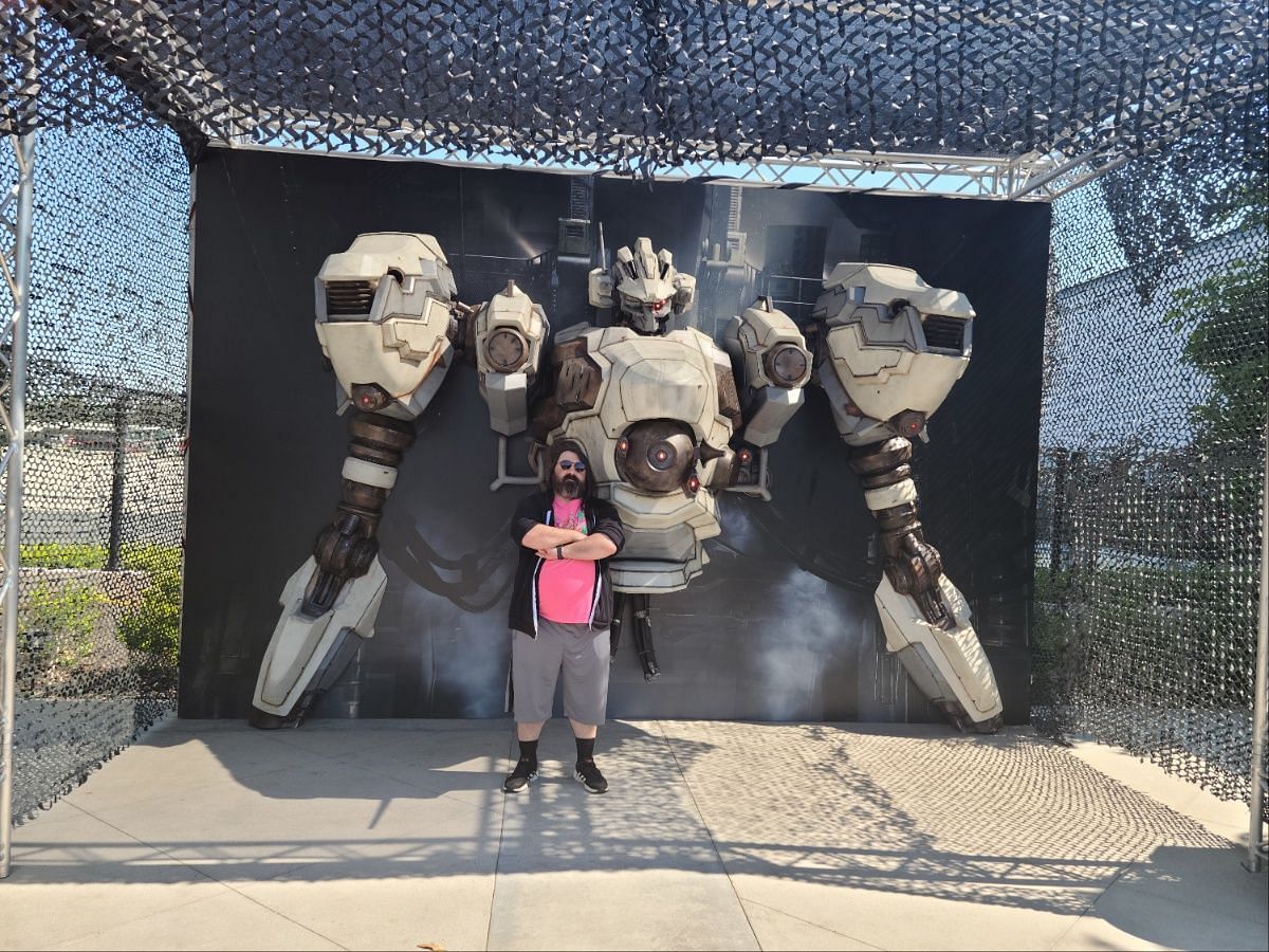 Here I am, posing with a massive AC prop at the event (Image via Sportskeeda)