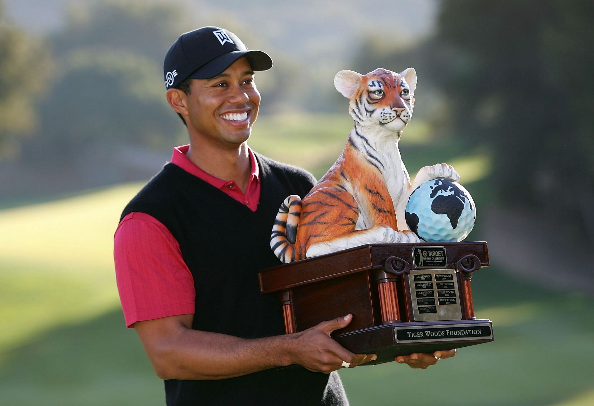 Tiger Woods holding the trophy of the 2007 Target World Challenge (now named Hero World Challenge) Image via Getty).