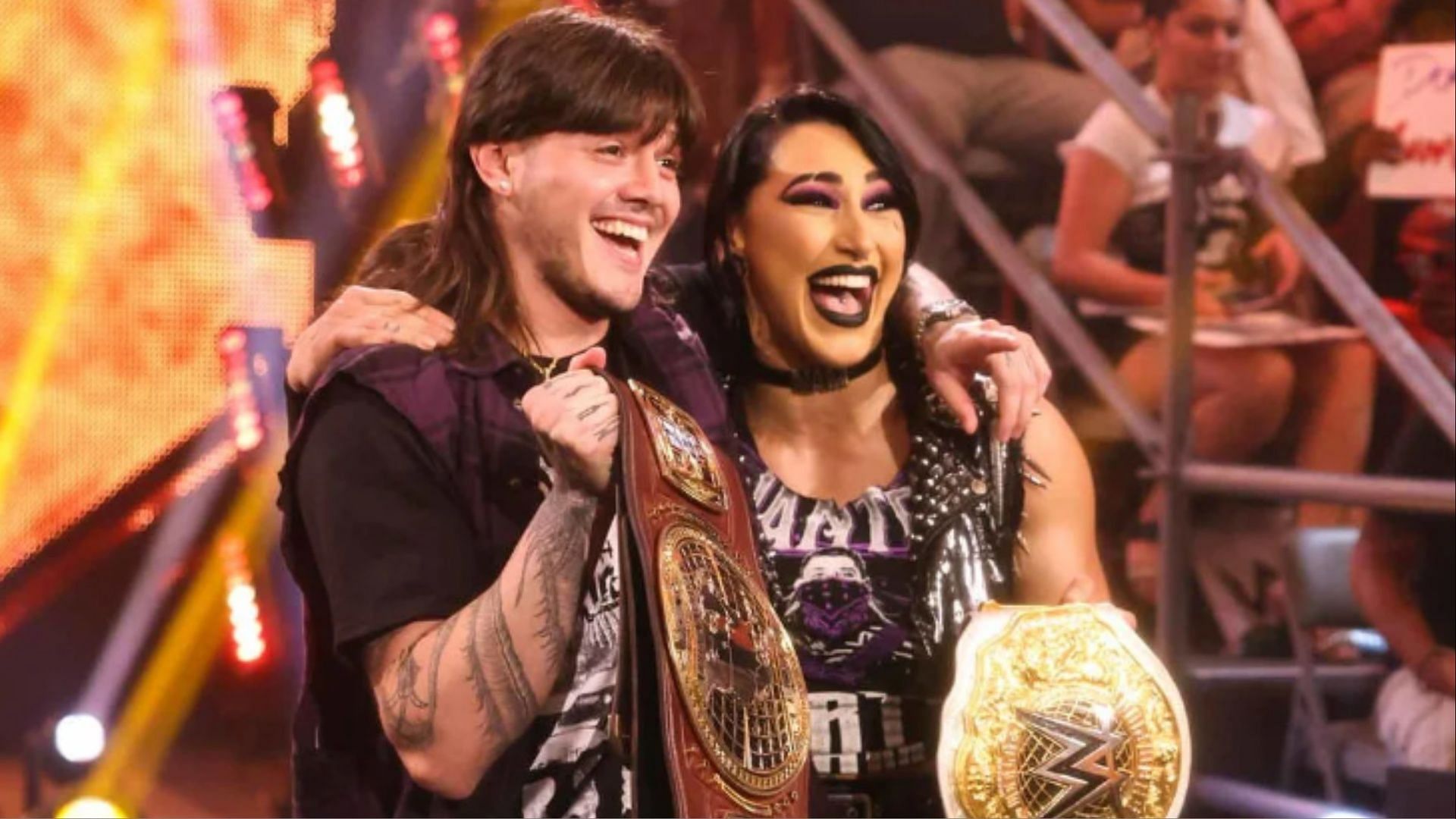 Dominik Mysterio and Rhea Ripley with their titles on WW NXT.