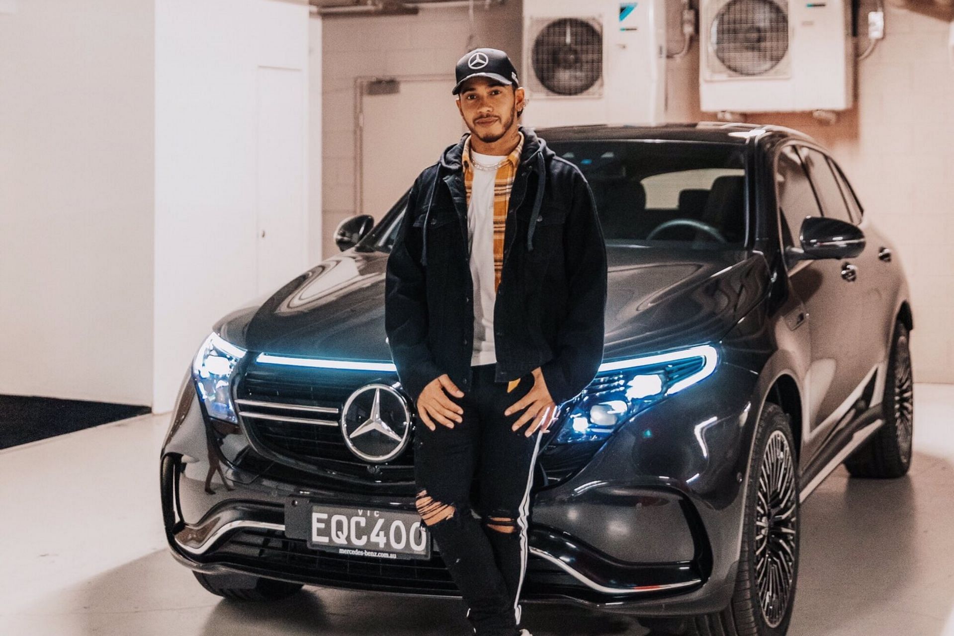 Hamilton with his new Mercedes-Benz EQC back in 2022 (Image via Twitter/@MercedesAMGF1)