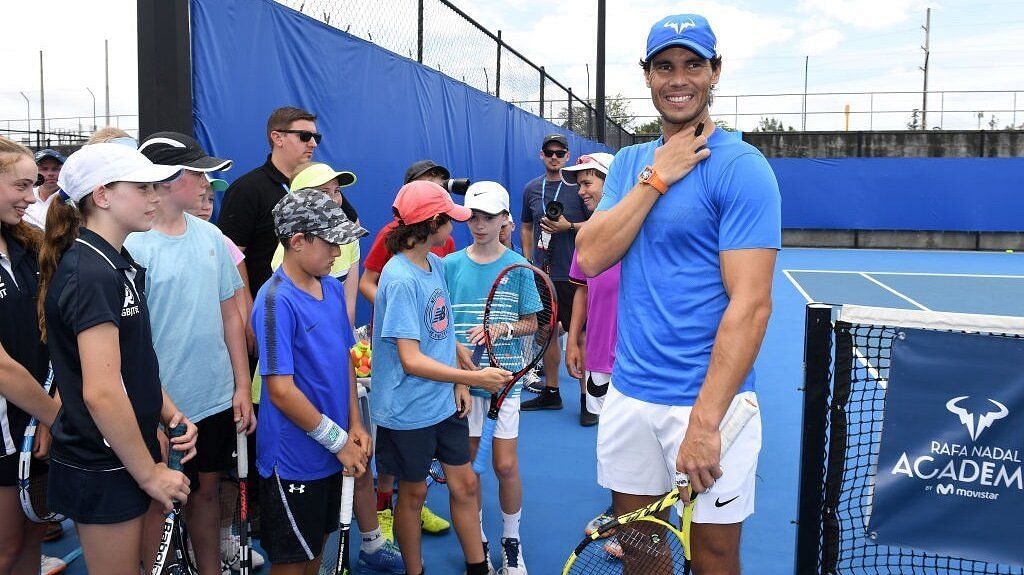 Rafael Nadal poses with kids at his academy