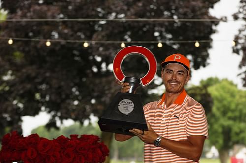 Rickie Fowler poses with the trophy after winning the Rocket Mortgage Classic in a playoff