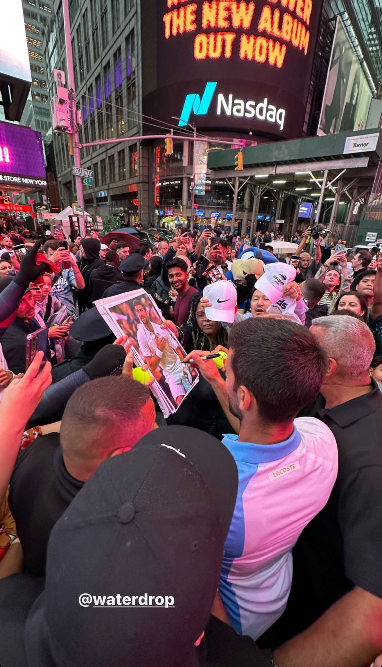 The 23-time Major winner signs some autographs in Times Square