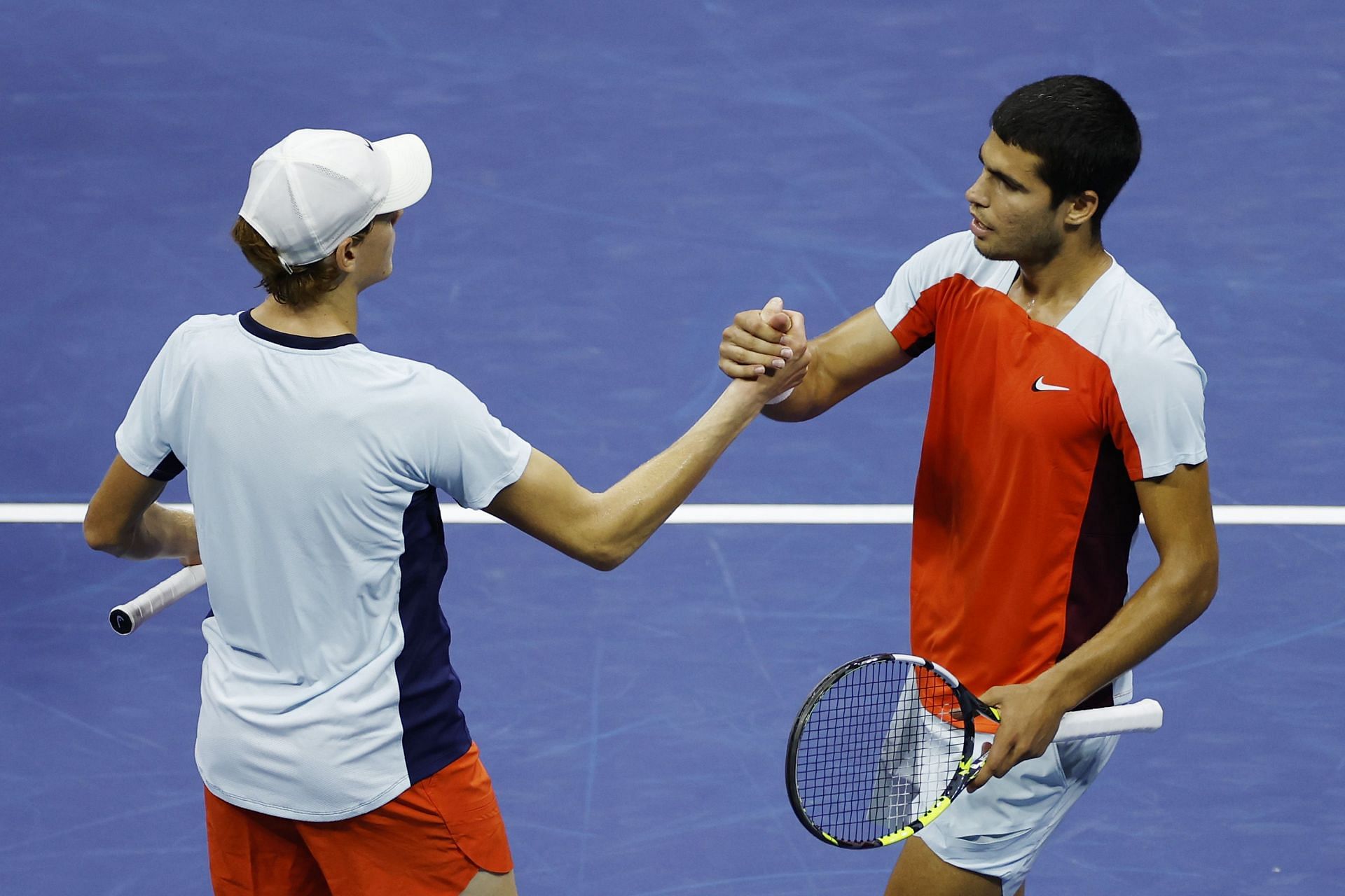 Jannik Sinner and Carlos Alcaraz greet each other.