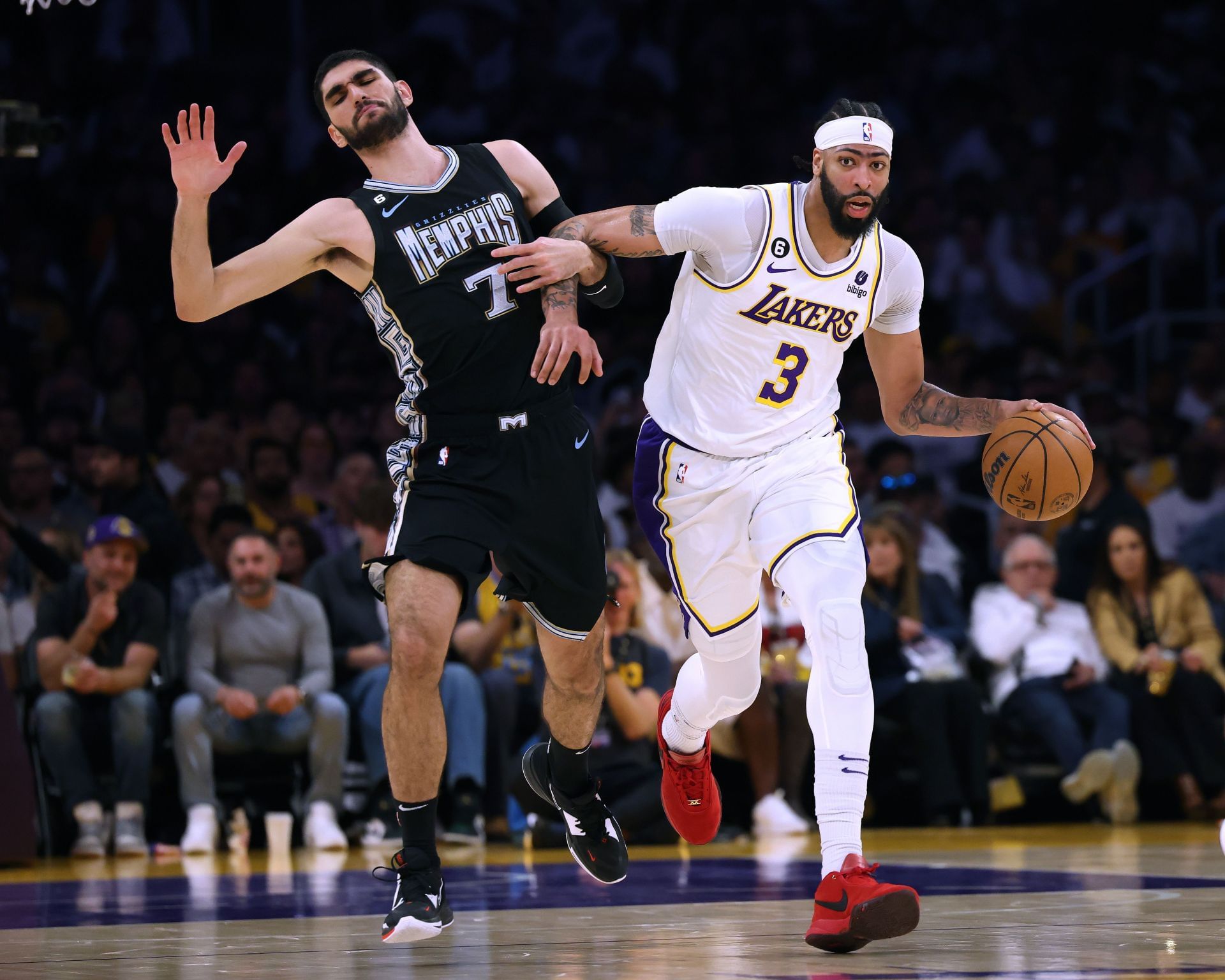 Santi Aldama (left) hustles against LA Lakers superstar Anthony Davis